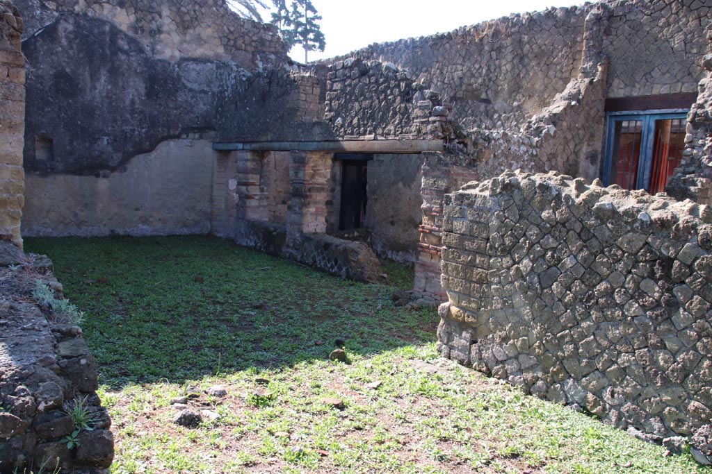 Ins. Orientalis I.3, Herculaneum, October 2022.
Looking south-east towards area from two doorways in north wall of atrium of Ins.Or.I.2. Photo courtesy of Klaus Heese.